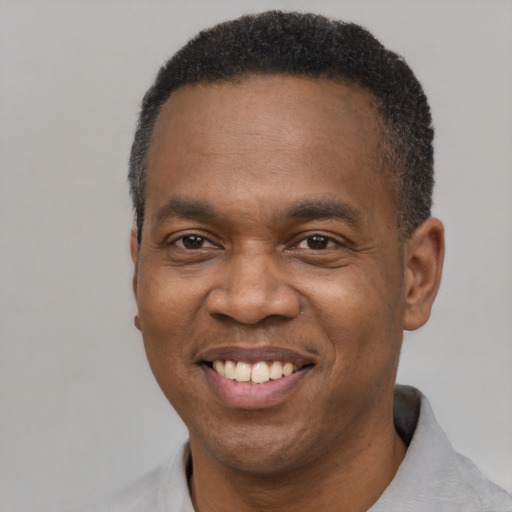 Joyful latino adult male with short  black hair and brown eyes