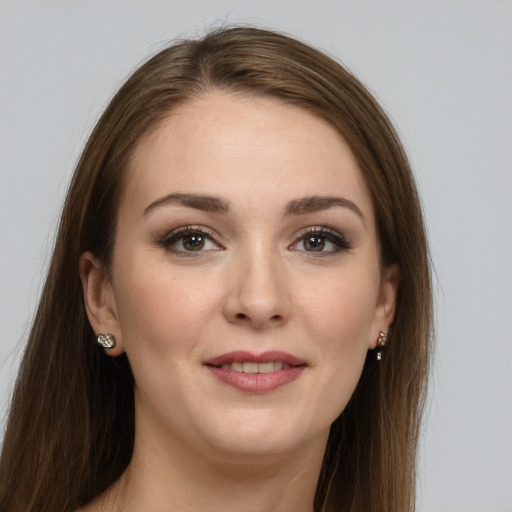 Joyful white young-adult female with long  brown hair and grey eyes