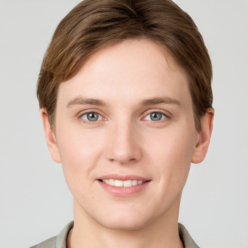 Joyful white young-adult female with short  brown hair and grey eyes