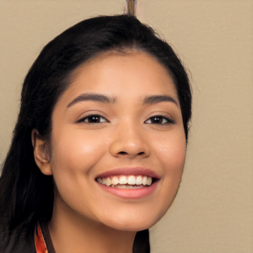 Joyful latino young-adult female with long  black hair and brown eyes