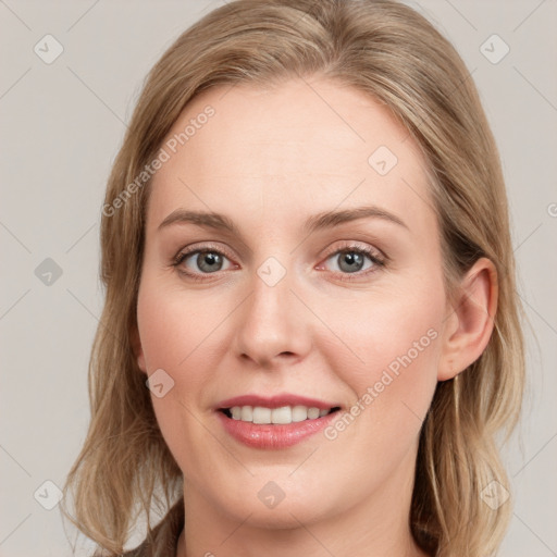 Joyful white young-adult female with long  brown hair and blue eyes