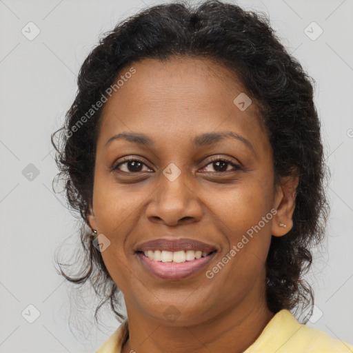 Joyful black adult female with long  brown hair and brown eyes