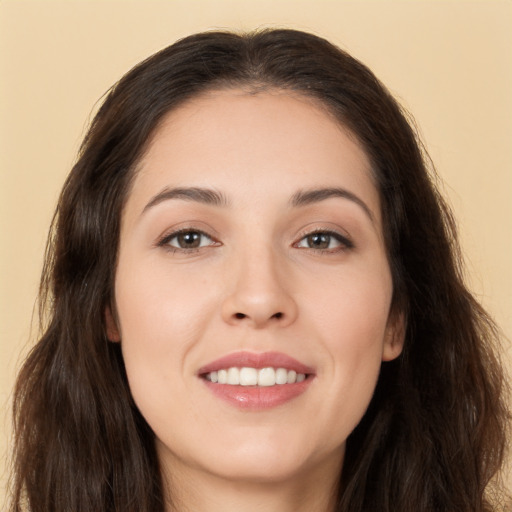 Joyful white young-adult female with long  brown hair and brown eyes