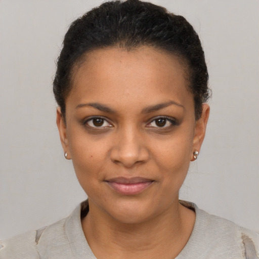 Joyful black young-adult female with short  brown hair and brown eyes