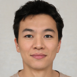 Joyful asian young-adult male with short  brown hair and brown eyes