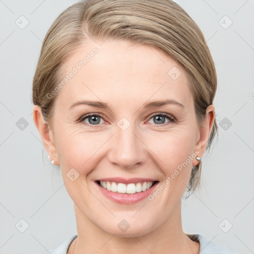 Joyful white young-adult female with medium  brown hair and blue eyes