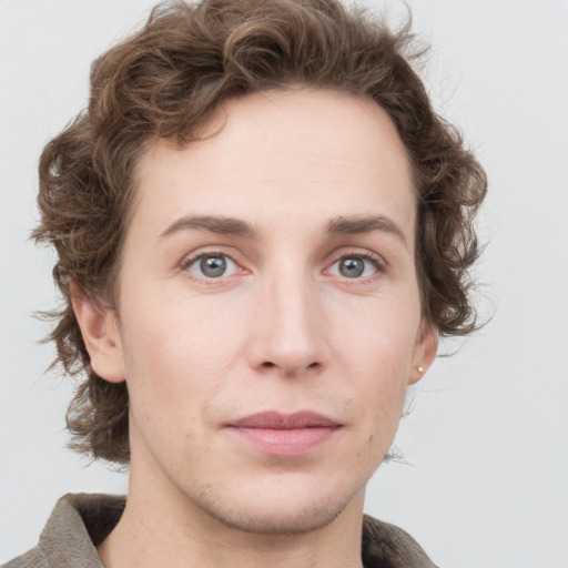 Joyful white young-adult male with medium  brown hair and grey eyes