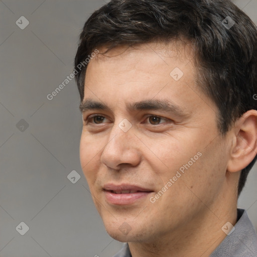 Joyful white young-adult male with short  black hair and brown eyes