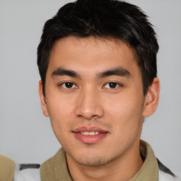 Joyful asian young-adult male with short  brown hair and brown eyes