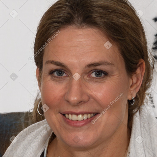 Joyful white adult female with medium  brown hair and blue eyes