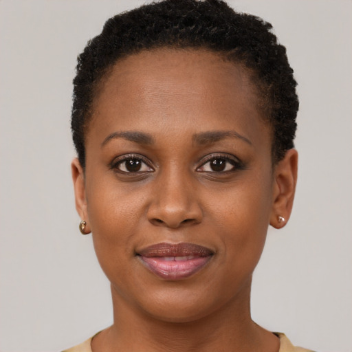 Joyful black young-adult female with short  brown hair and brown eyes