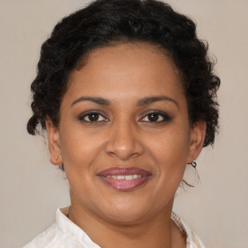 Joyful black young-adult female with medium  brown hair and brown eyes
