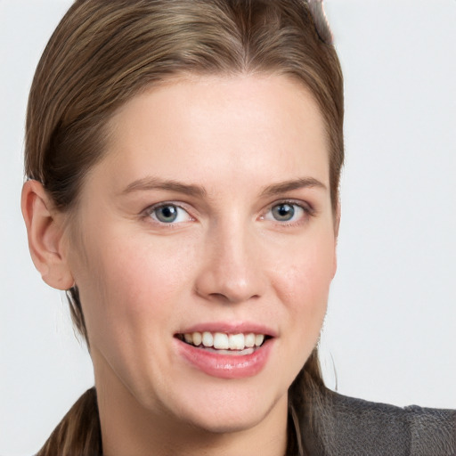 Joyful white young-adult female with long  brown hair and blue eyes