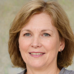 Joyful white adult female with medium  brown hair and blue eyes