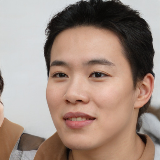 Joyful asian young-adult male with medium  brown hair and brown eyes