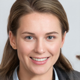 Joyful white young-adult female with long  brown hair and blue eyes