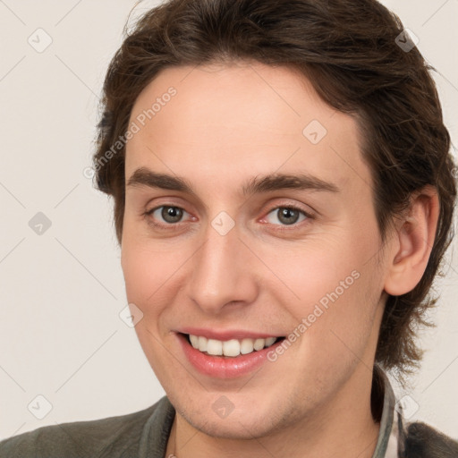 Joyful white young-adult male with medium  brown hair and brown eyes