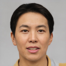 Joyful asian young-adult male with short  brown hair and brown eyes