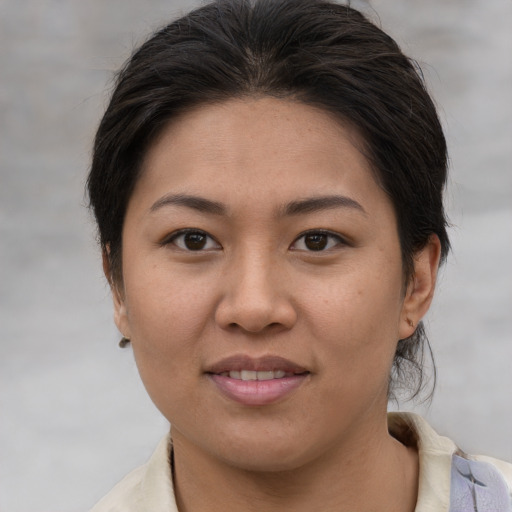 Joyful asian young-adult female with medium  brown hair and brown eyes