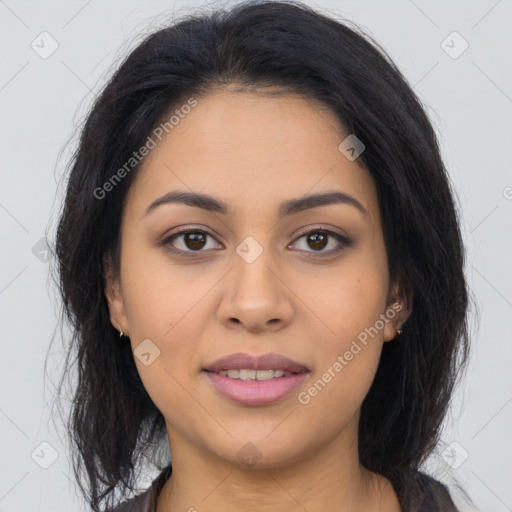 Joyful latino young-adult female with long  brown hair and brown eyes