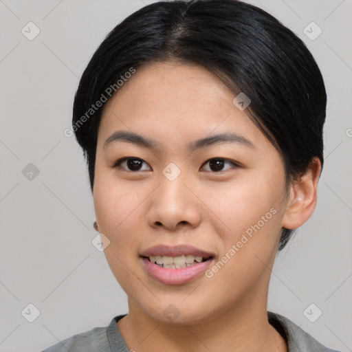 Joyful asian young-adult female with short  black hair and brown eyes