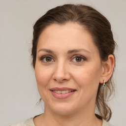 Joyful white young-adult female with medium  brown hair and green eyes