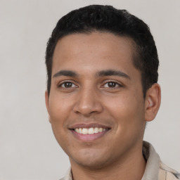 Joyful latino young-adult male with short  black hair and brown eyes