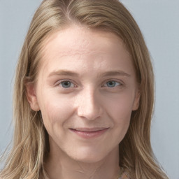 Joyful white young-adult female with long  brown hair and blue eyes