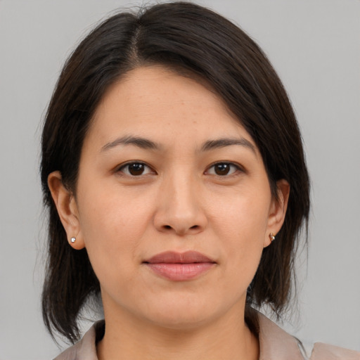 Joyful asian young-adult female with medium  brown hair and brown eyes