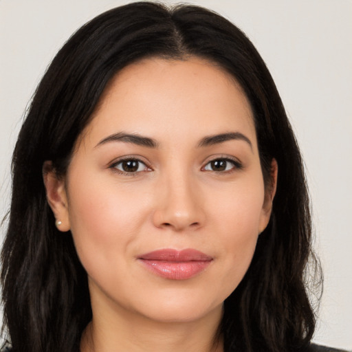 Joyful latino young-adult female with long  brown hair and brown eyes