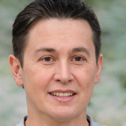 Joyful white adult male with short  brown hair and brown eyes