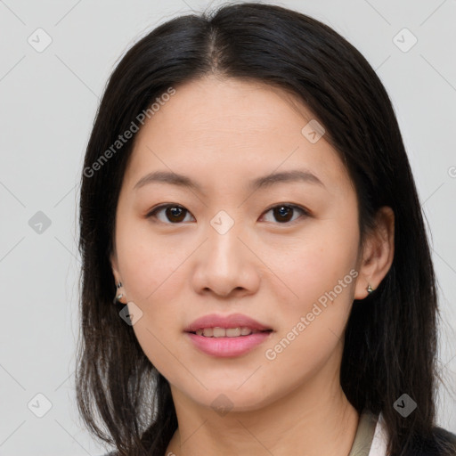 Joyful asian young-adult female with long  brown hair and brown eyes