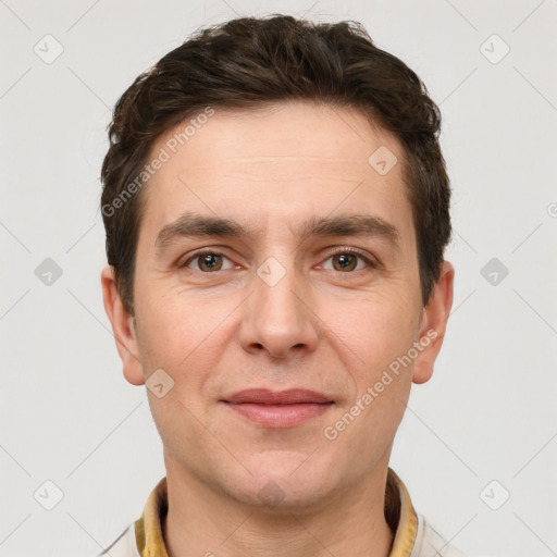 Joyful white young-adult male with short  brown hair and grey eyes