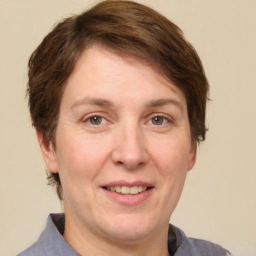 Joyful white adult female with short  brown hair and grey eyes