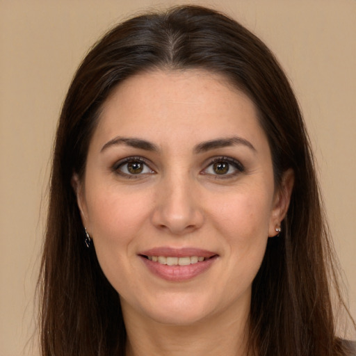 Joyful white young-adult female with long  brown hair and brown eyes