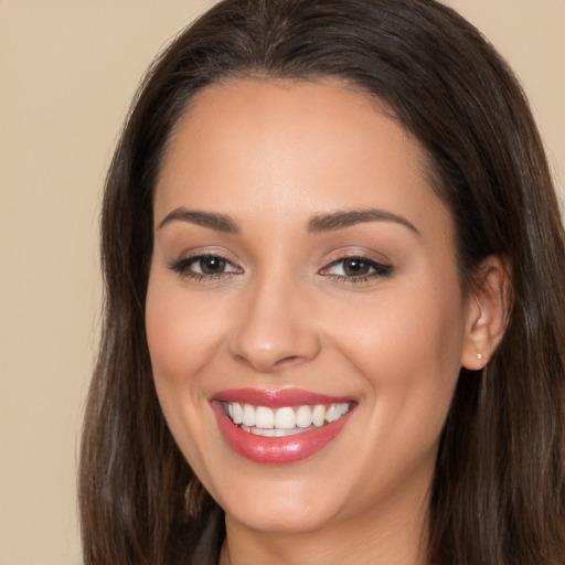 Joyful white young-adult female with long  brown hair and brown eyes