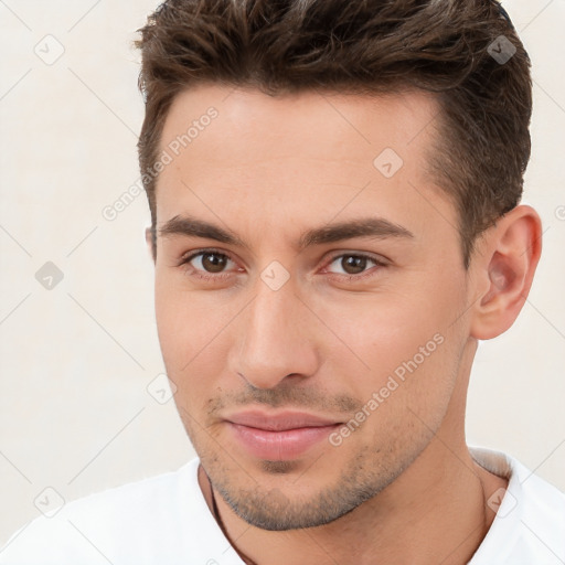 Joyful white young-adult male with short  brown hair and brown eyes