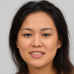 Joyful asian young-adult female with long  brown hair and brown eyes