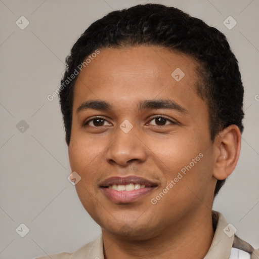 Joyful latino young-adult male with short  black hair and brown eyes