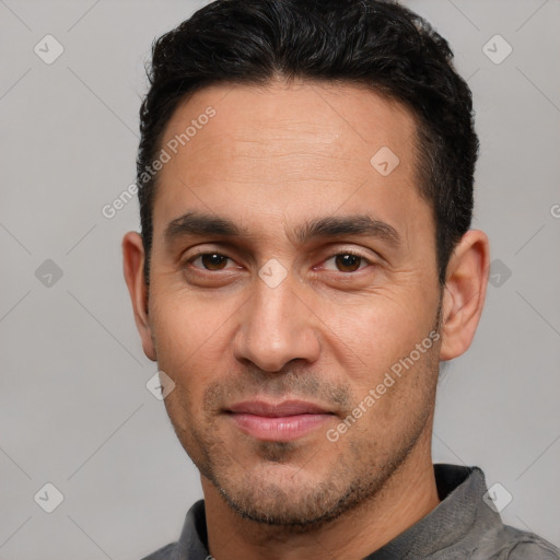 Joyful white adult male with short  brown hair and brown eyes