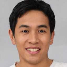 Joyful asian young-adult male with short  black hair and brown eyes