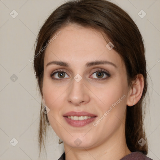 Joyful white young-adult female with medium  brown hair and green eyes