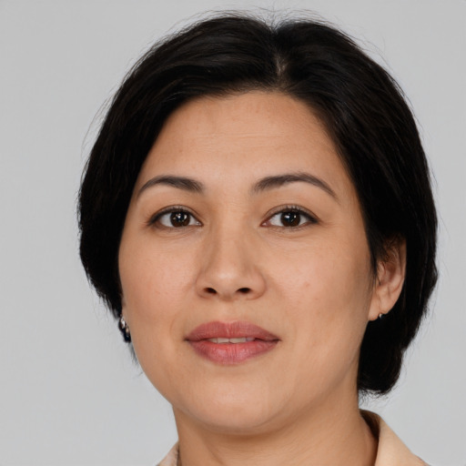 Joyful asian adult female with medium  brown hair and brown eyes