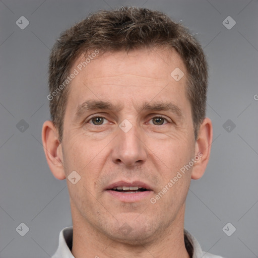 Joyful white adult male with short  brown hair and brown eyes