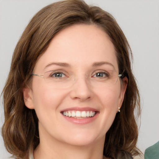 Joyful white young-adult female with medium  brown hair and green eyes