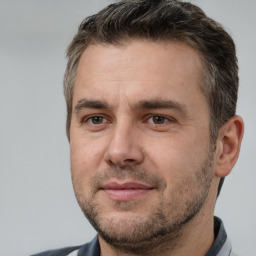 Joyful white adult male with short  brown hair and brown eyes