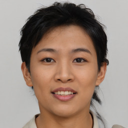 Joyful asian young-adult female with short  brown hair and brown eyes