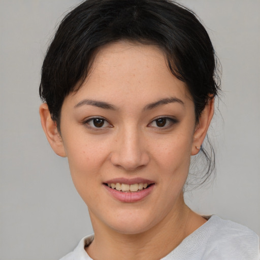 Joyful asian young-adult female with short  brown hair and brown eyes