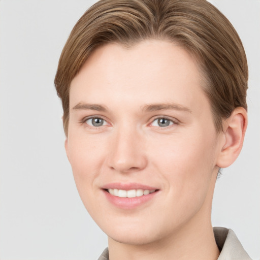 Joyful white young-adult female with short  brown hair and grey eyes