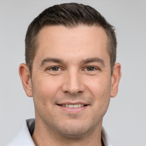 Joyful white adult male with short  brown hair and brown eyes